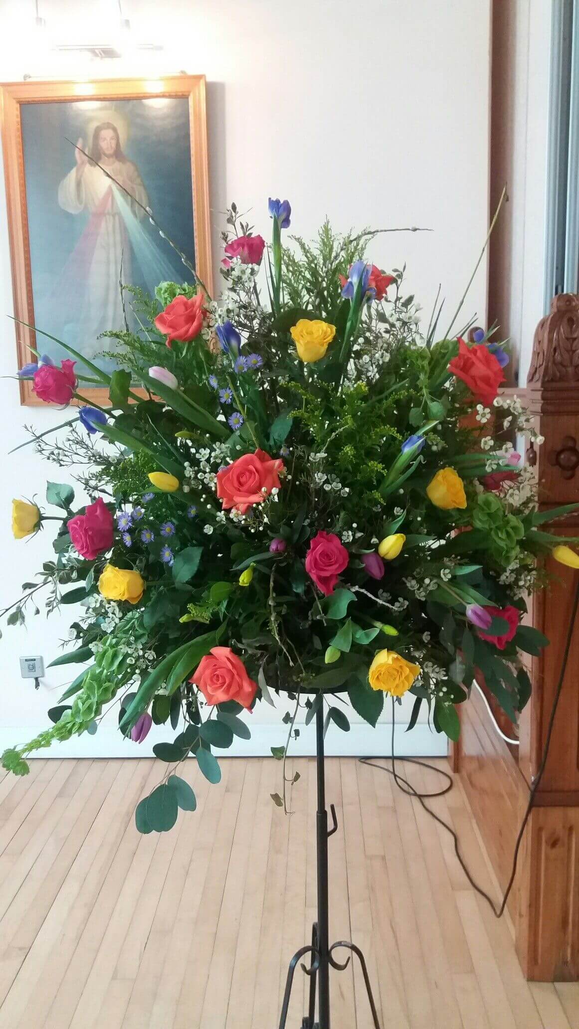 Bright mixed pedestal wedding flower arrangement